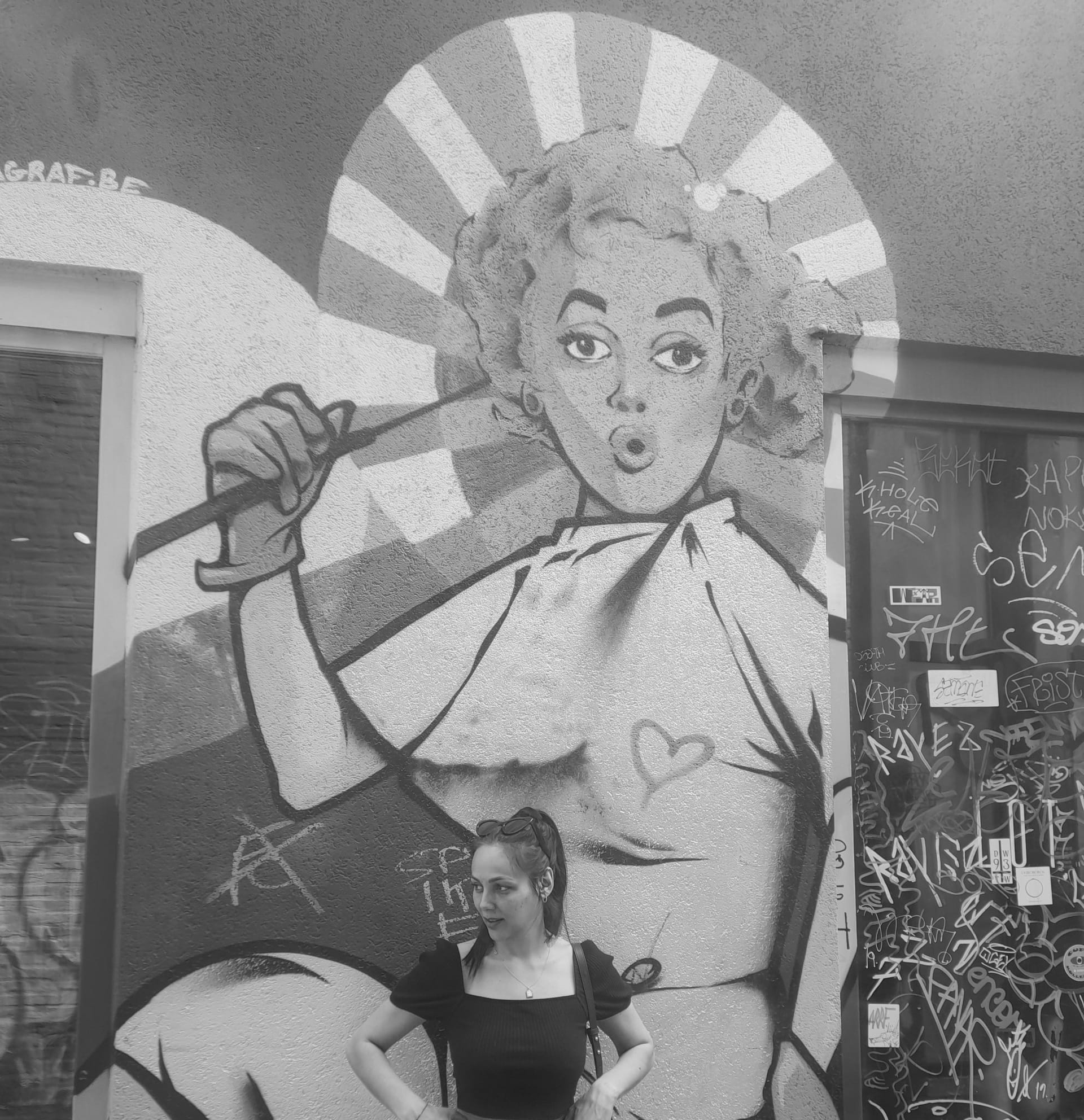 woman in front of a graffiti wall